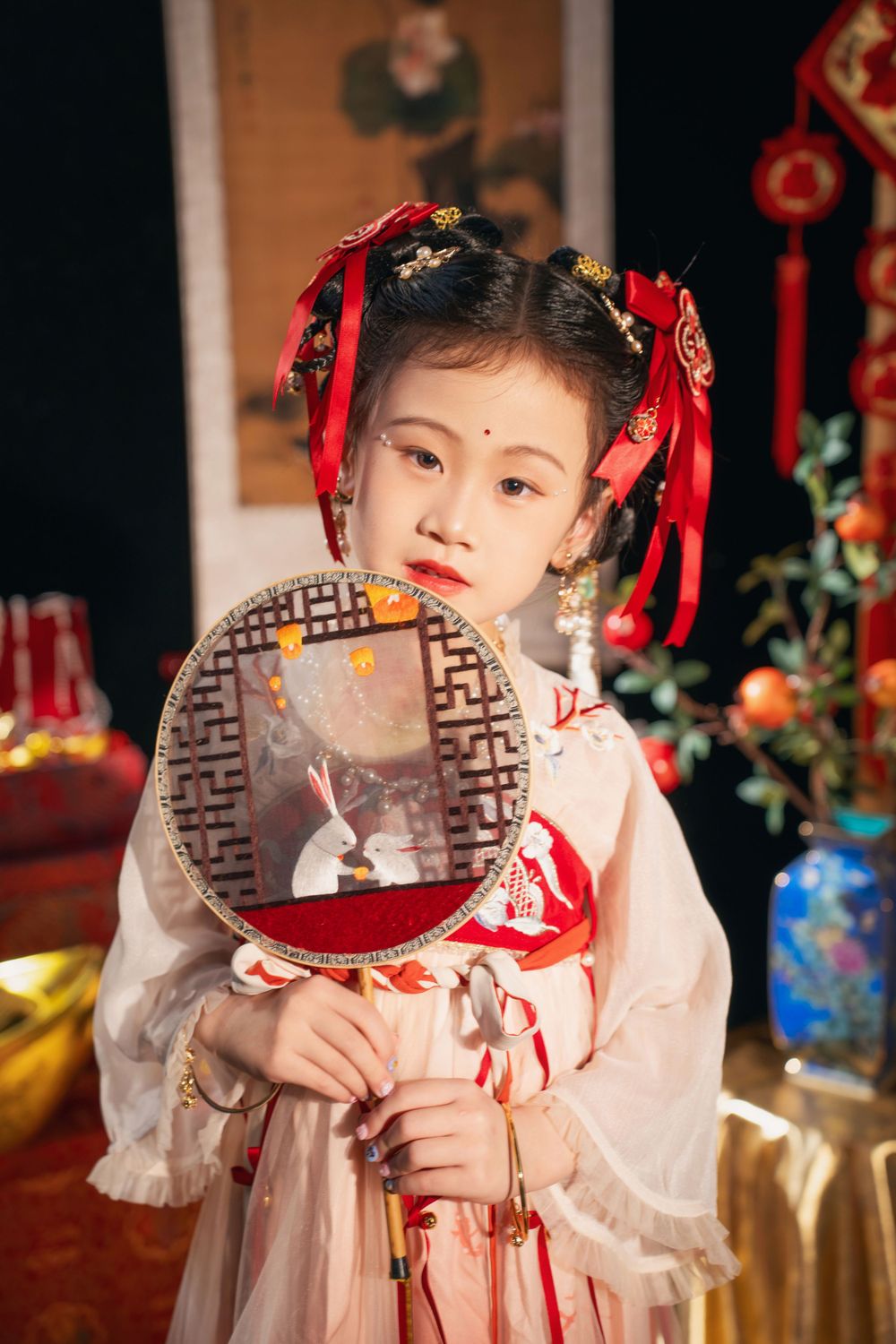 Cute children's studio portrait in an elegant Tang Dynasty Hanfu with dazzling golden props, by Imagine Image Studio.