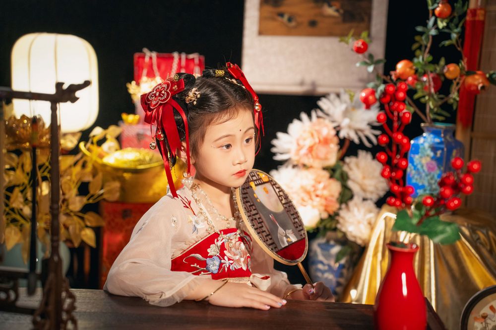 Cute children's studio portrait in an elegant Tang Dynasty Hanfu with dazzling golden props, by Imagine Image Studio.
