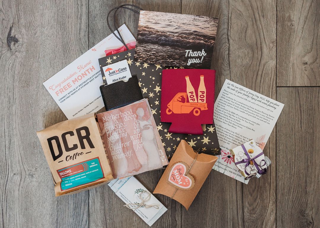 Flatlay of various branded marketing materials and business cards on wooden surface.