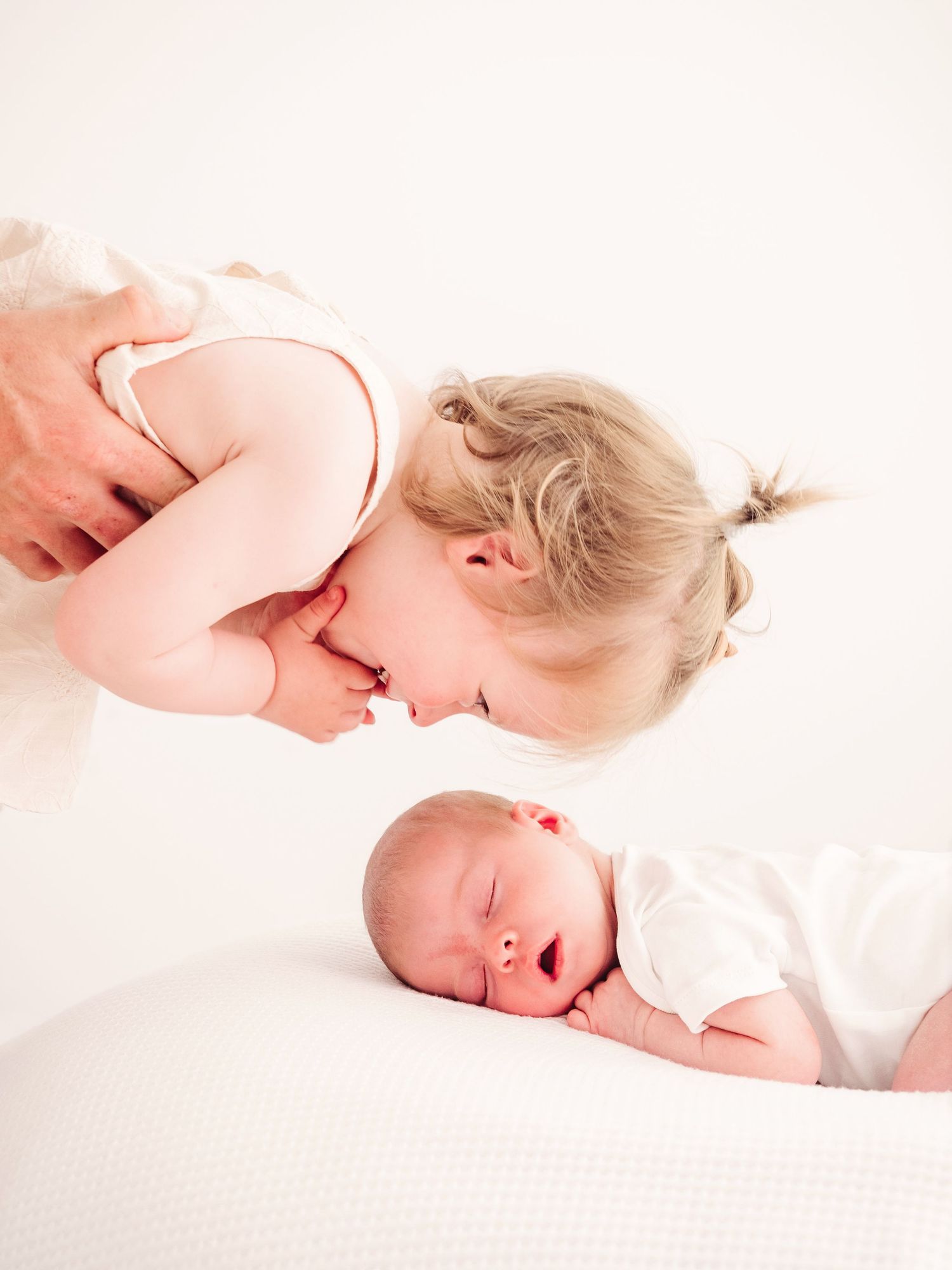 product photo of a triple folder with three photos from a newborn photo session