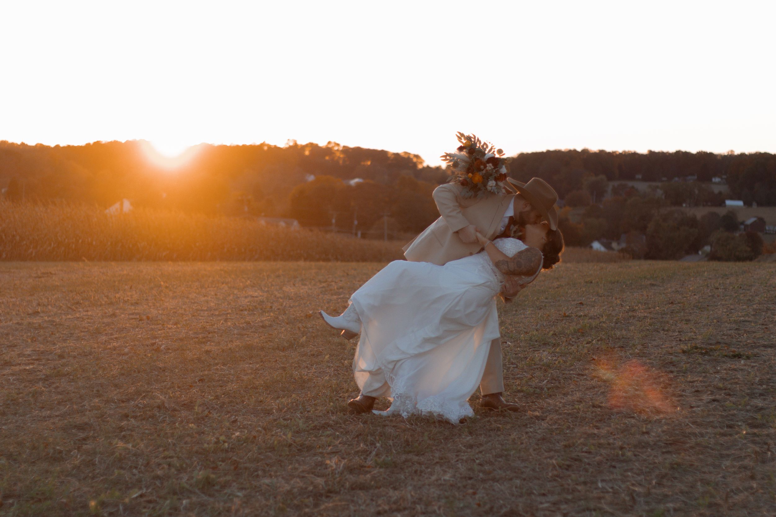 Golden hour wedding photography in a rustic outdoor setting.