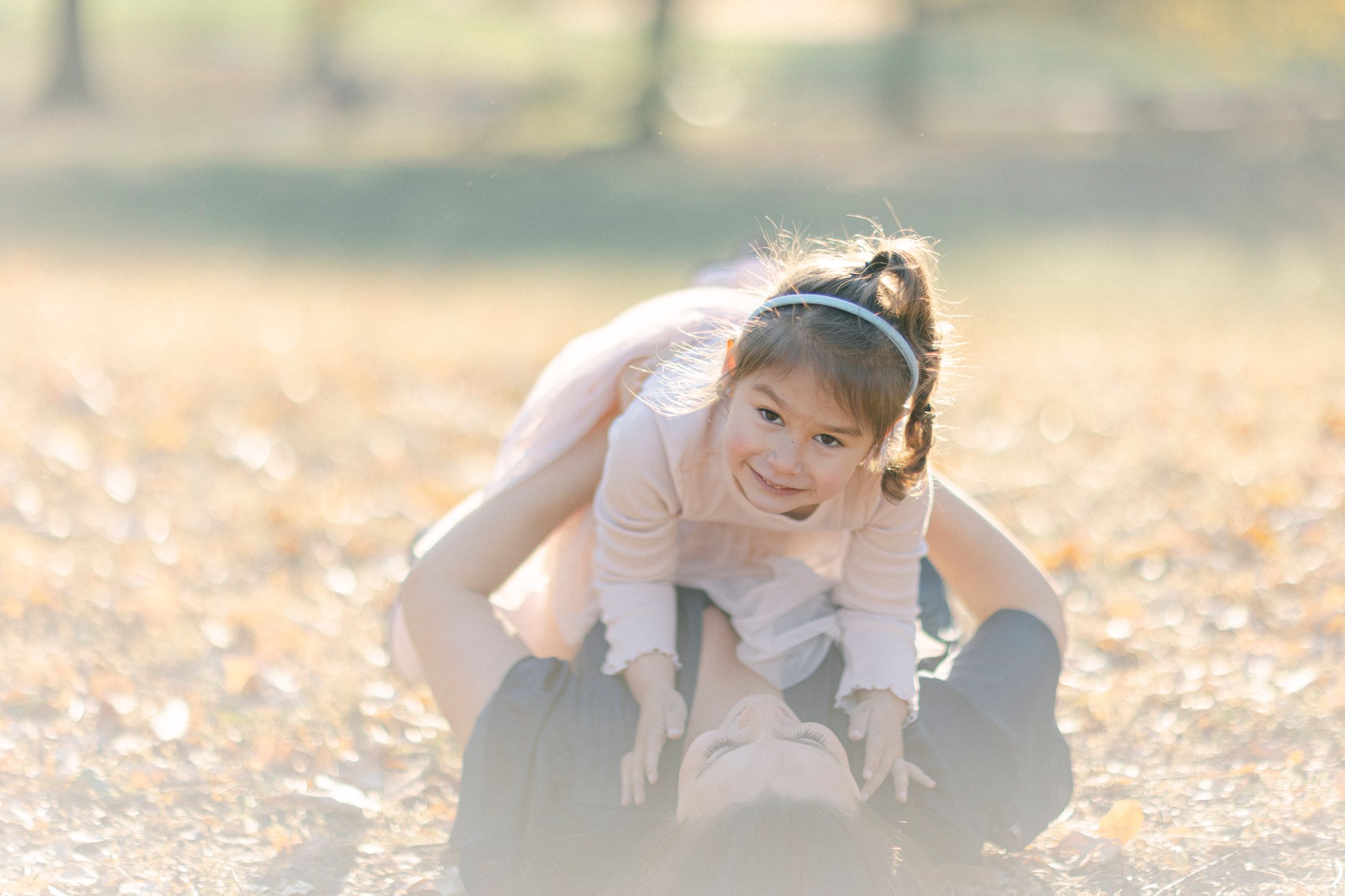 A cheerful outdoor play moment captured in soft natural lighting.