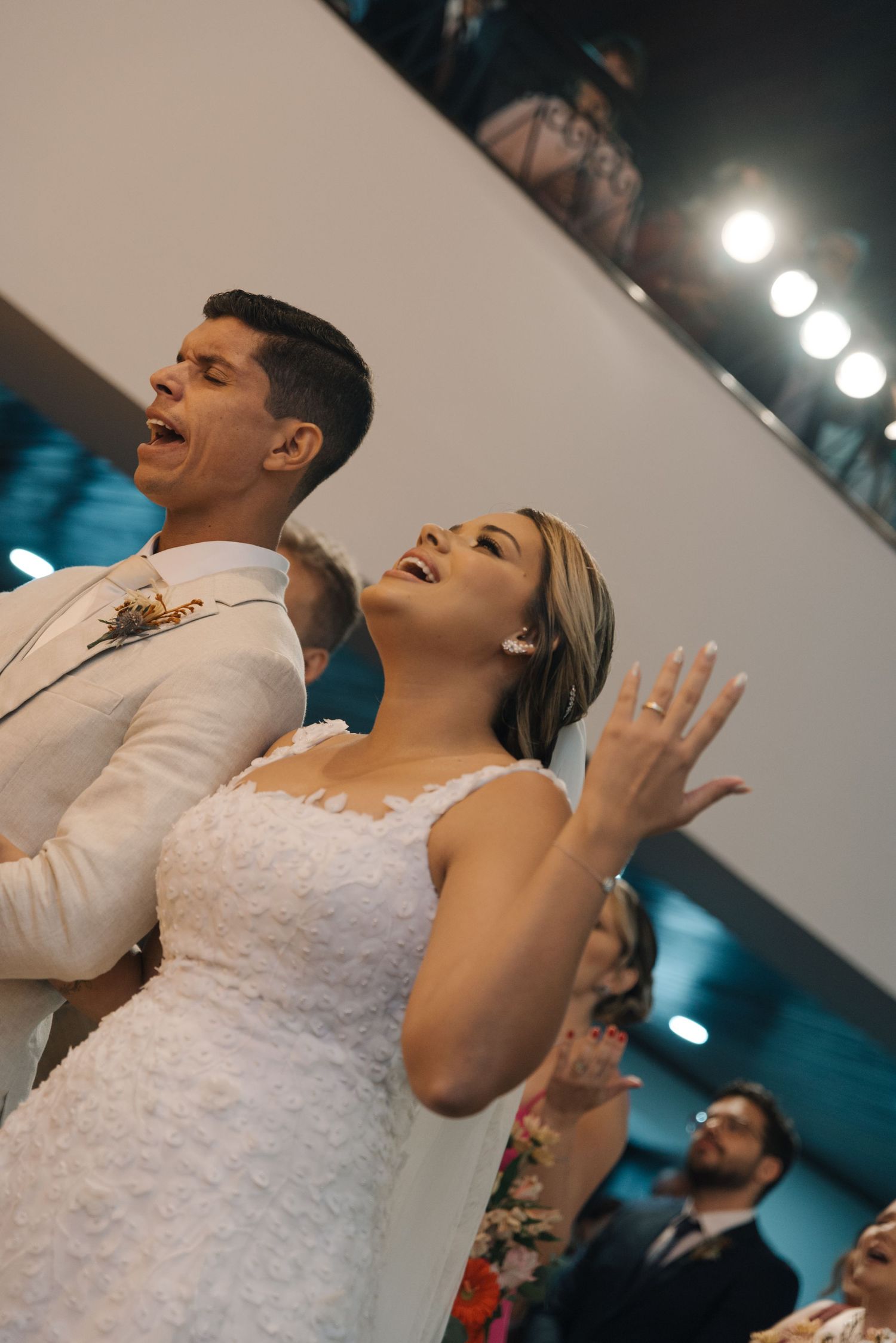 Bride and groom share a joyful moment of worship or celebration during their ceremony.