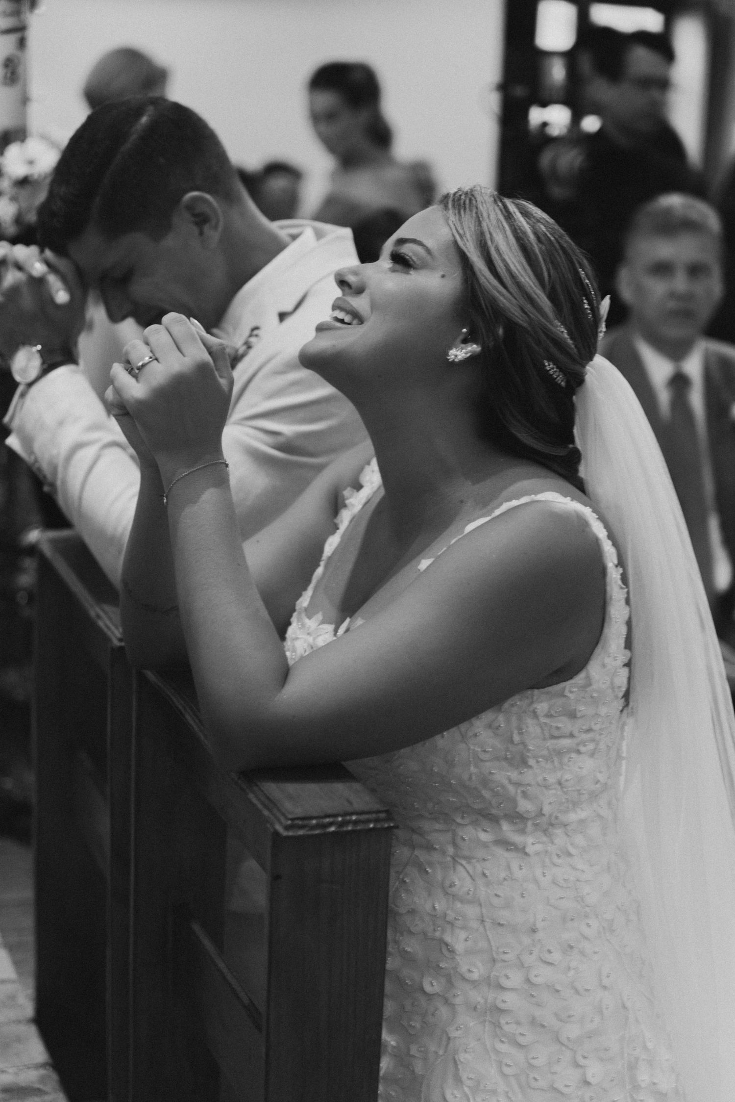 Black and white photo capturing an emotional moment during a wedding ceremony.
