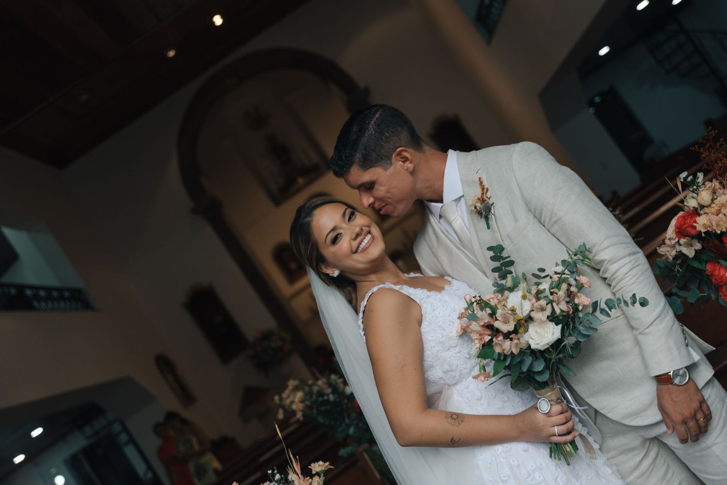 A candid wedding photo captures a couple's joy as they celebrate their special day.