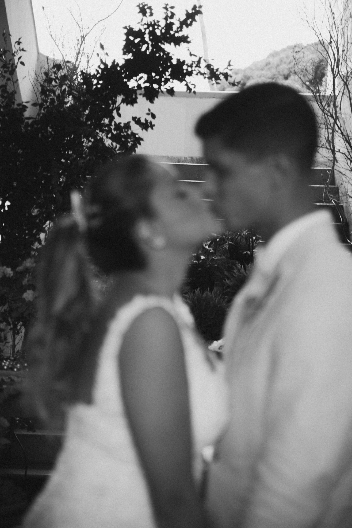 Artistic black and white portrait of a couple in an intimate moment at their wedding.