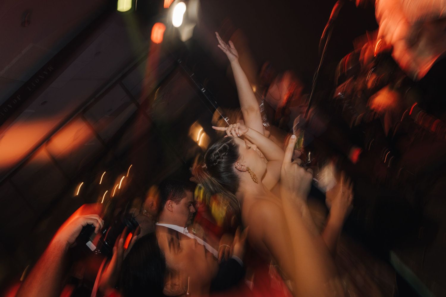 Motion-blurred shot of dancing and celebration at a wedding reception.