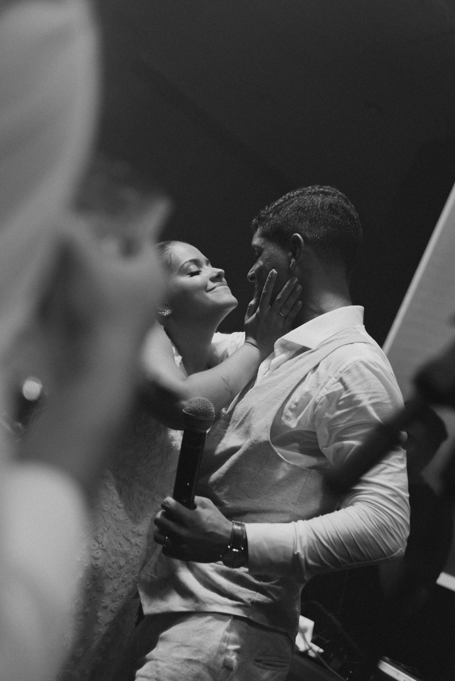 An intimate black and white portrait of a couple during their wedding dance.