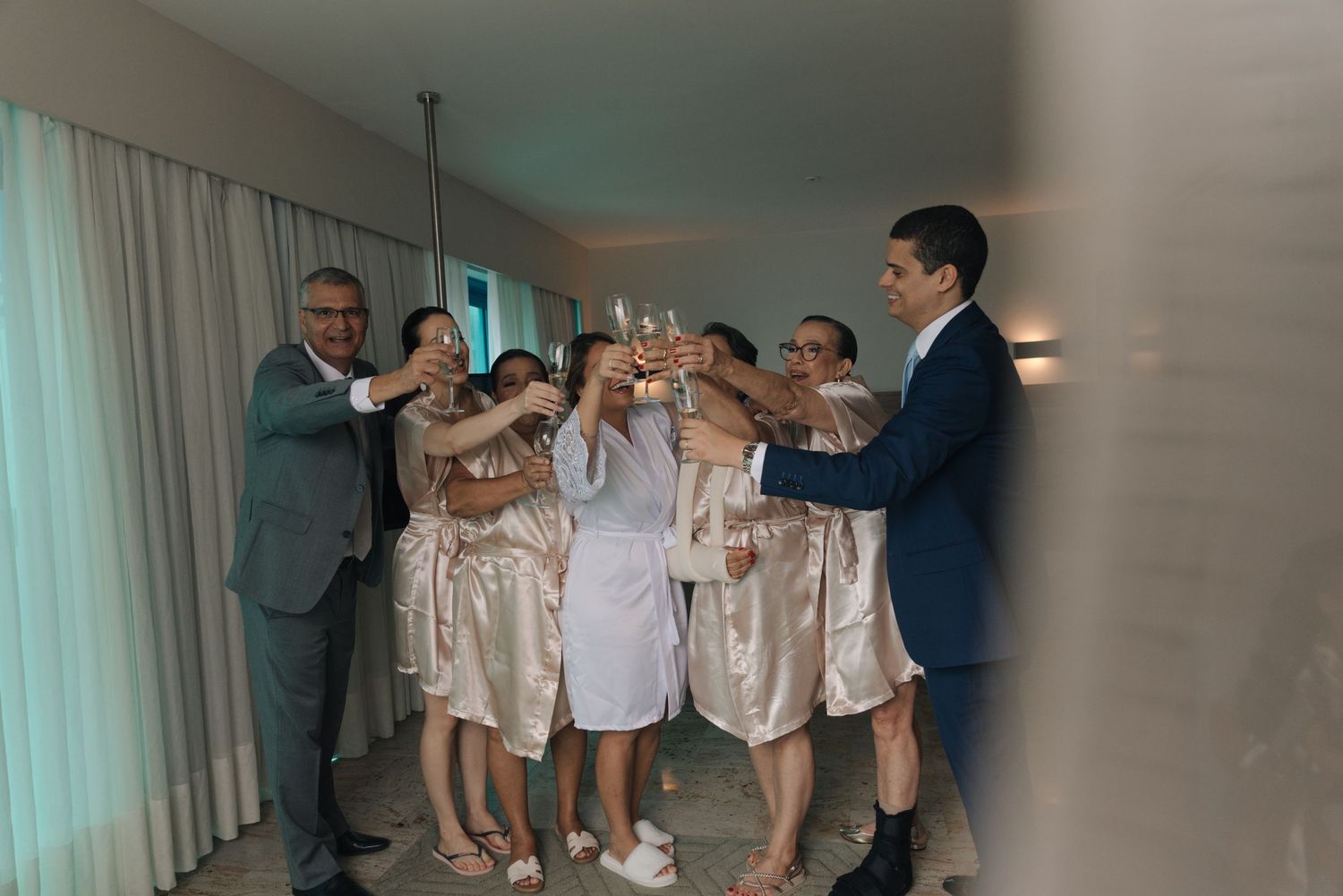 Wedding party toasting with champagne glasses in celebration.
