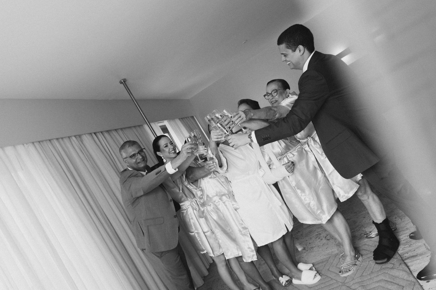 Black and white photo of wedding party group posing together.