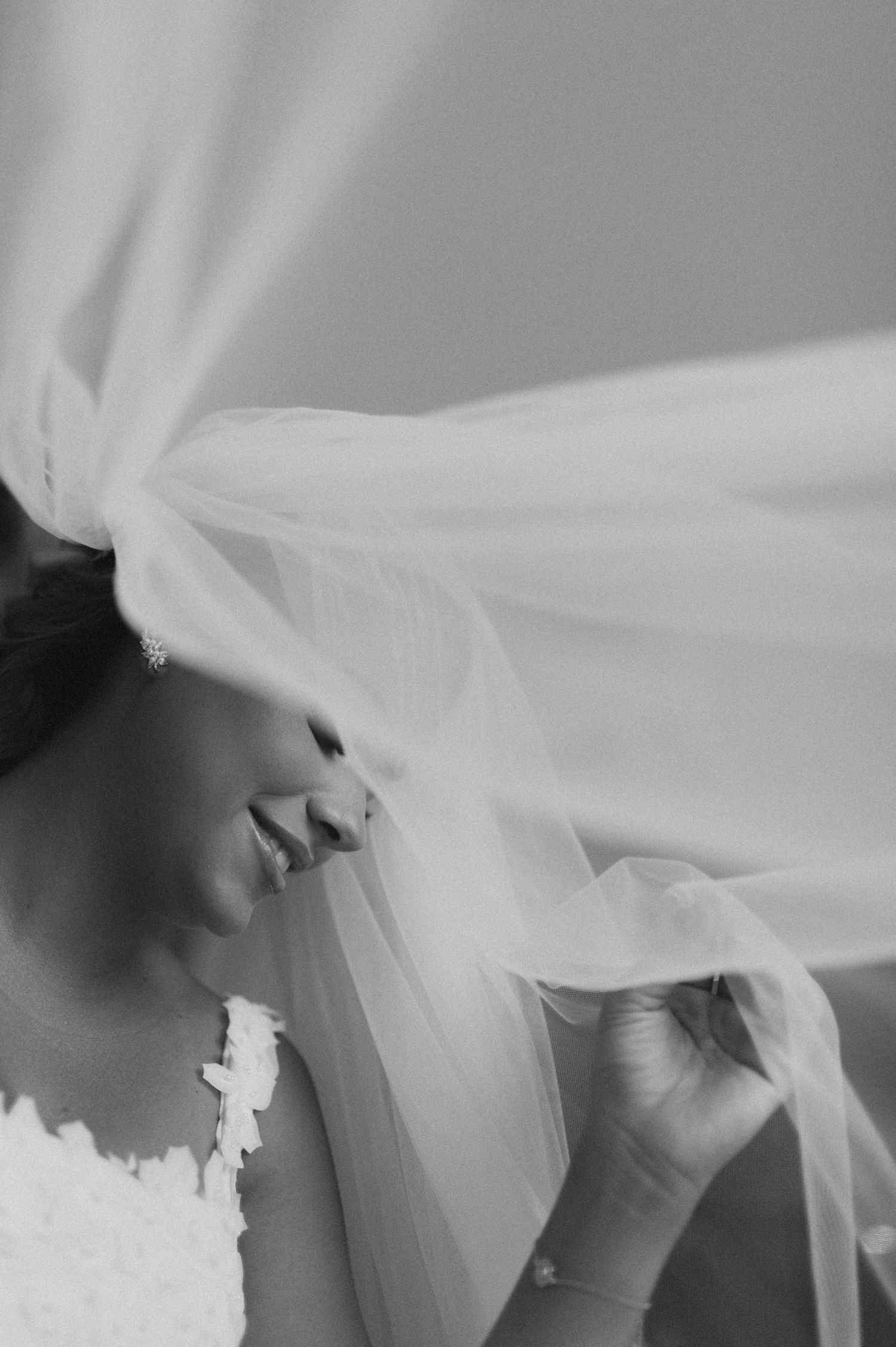 Artistic black and white close-up of flowing bridal veil.