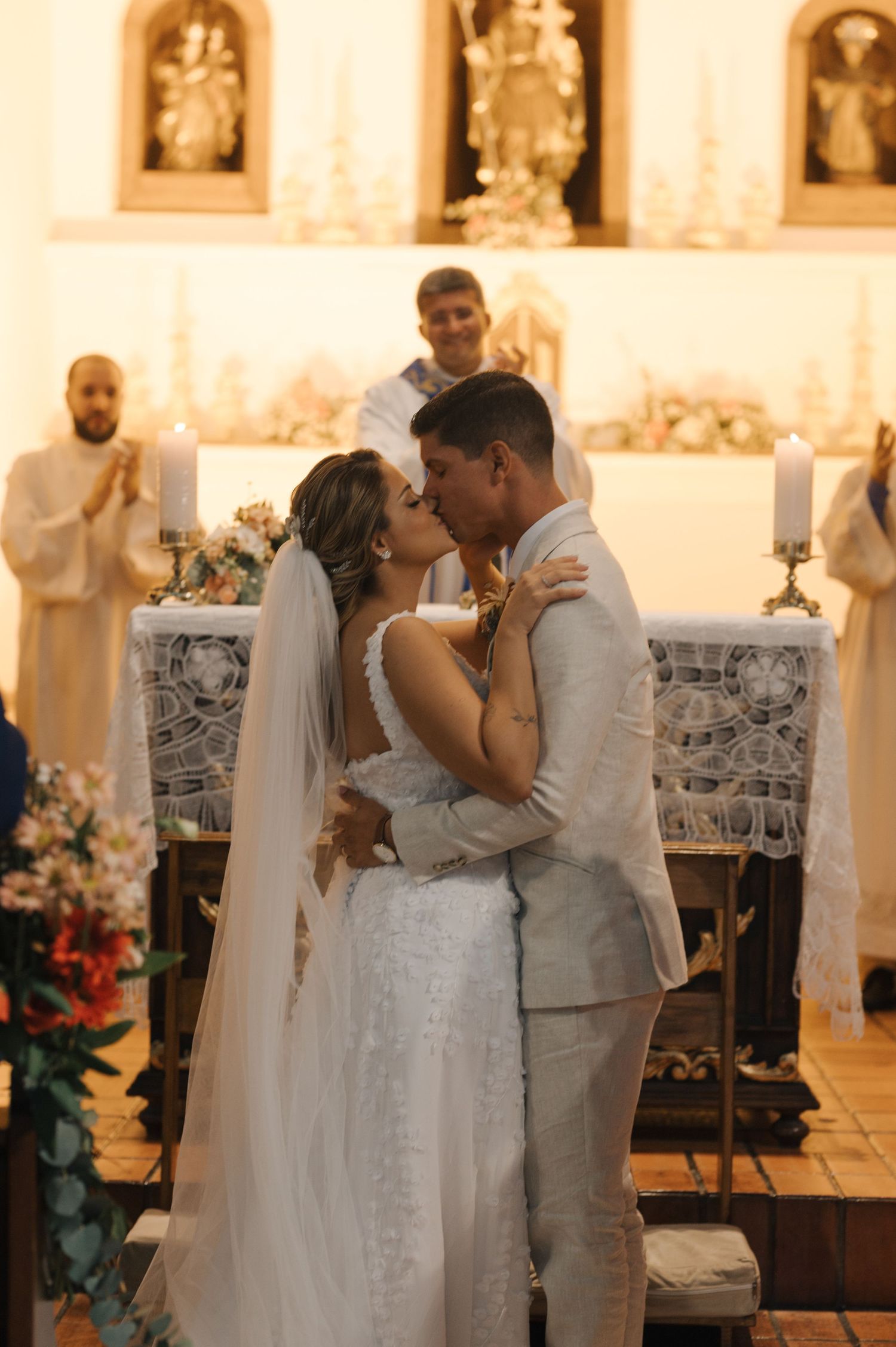 Newlyweds embrace in intimate moment during church wedding ceremony.