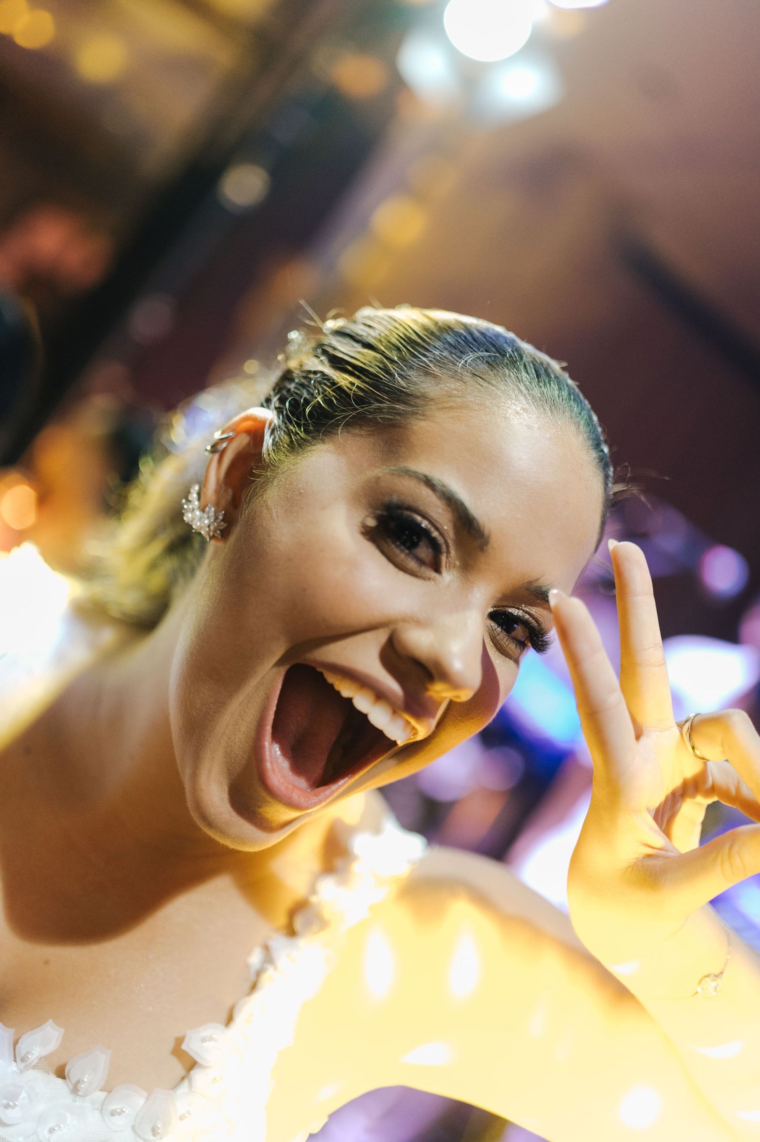 Close-up portrait with warm lighting and festive expression at celebration event.