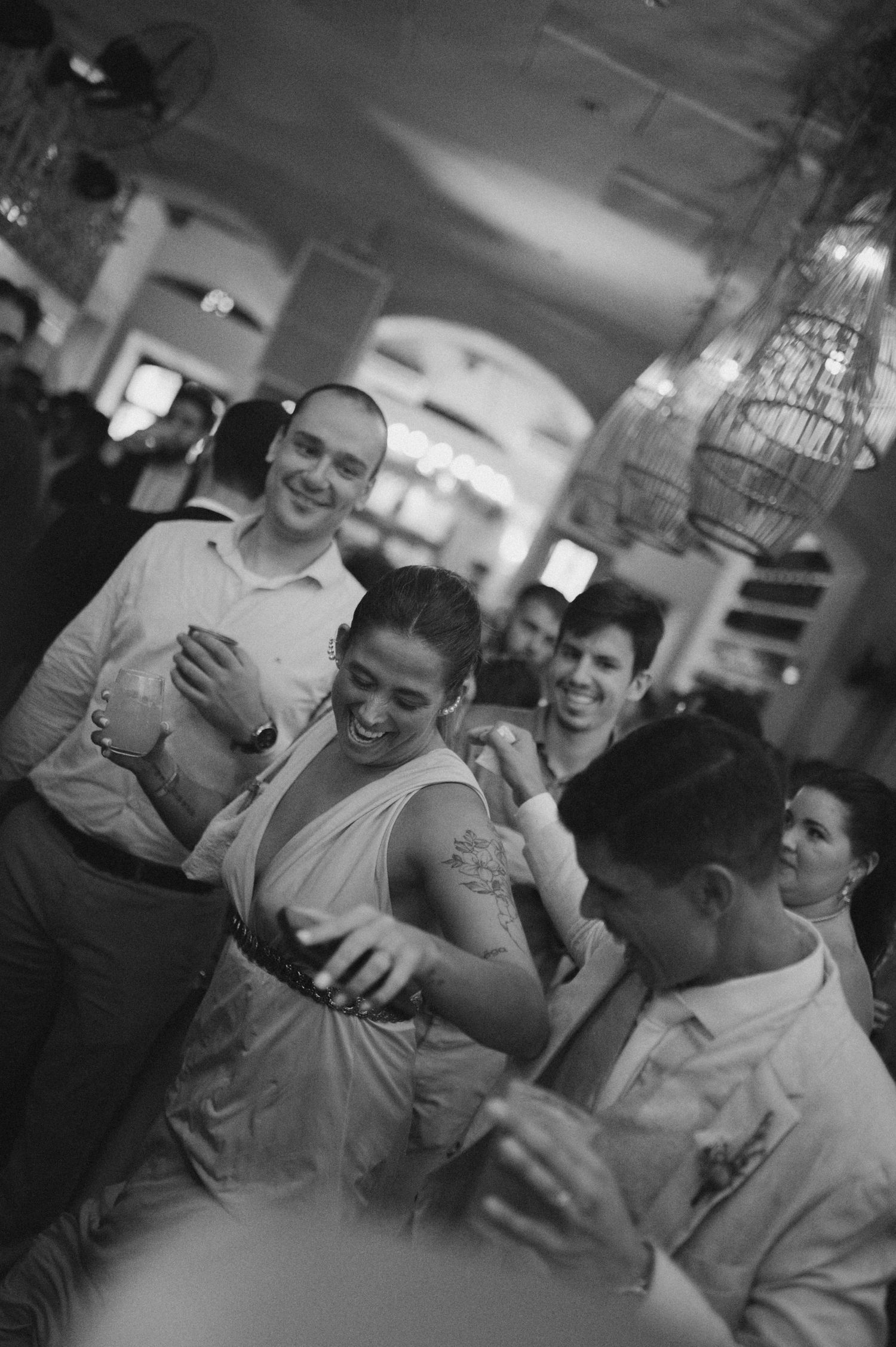 Black and white candid shot of celebration with joyful crowd interaction.
