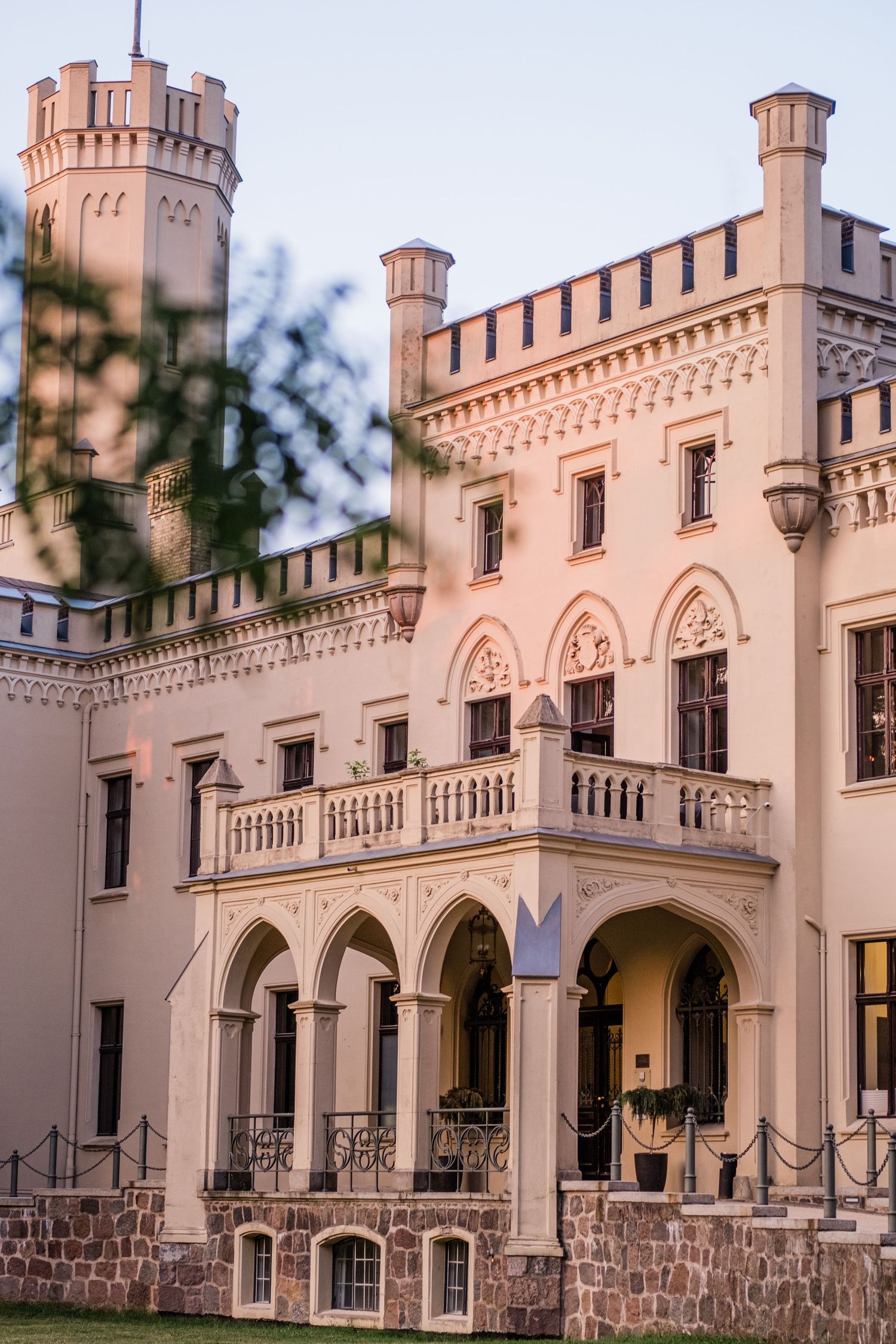 Ornate pink castle-like building with Gothic Revival architecture and towers. Organized wedding by MyCastleWedding | Dresden.