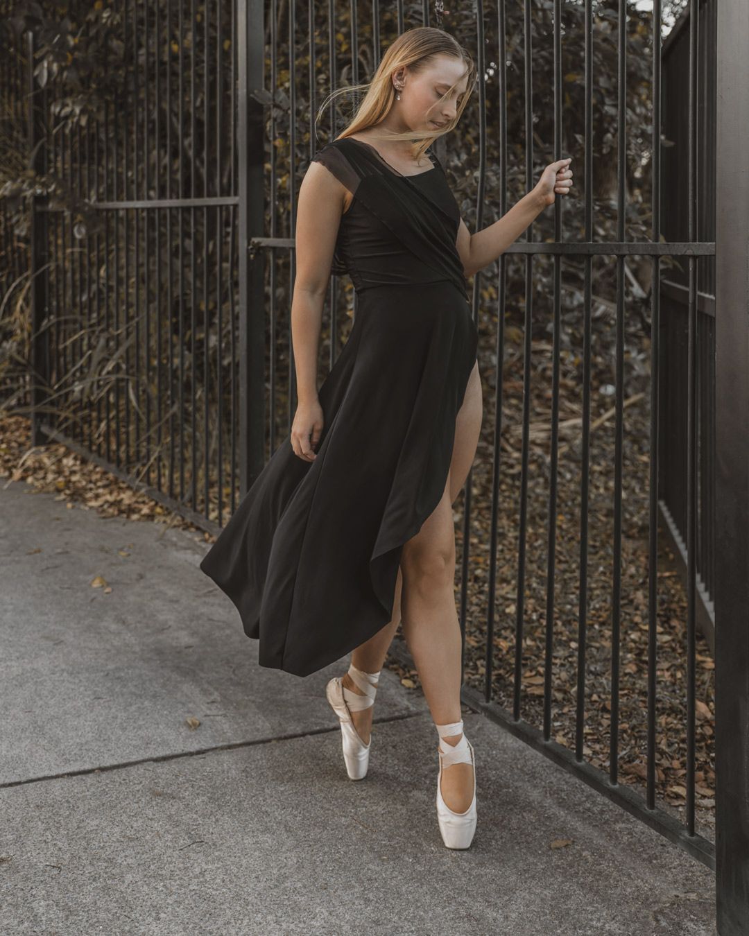 Elegant ballerina in black dress and white point shoes, photographed by Nick Wigmore Photography.
