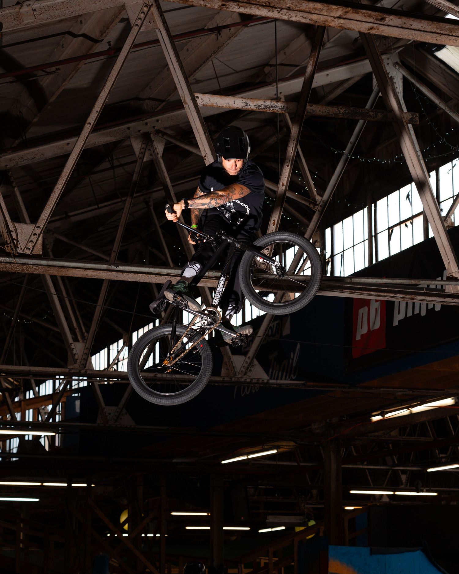 BMX rider doing a trick off a jump at Ray's Indoor Mountain Bike Park in Cleveland, Ohio.
