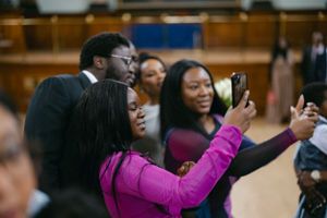 Event attendees using phones to capture memories during celebration.
