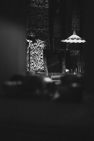 Black and white image of decorative lamps with patterned light projections.