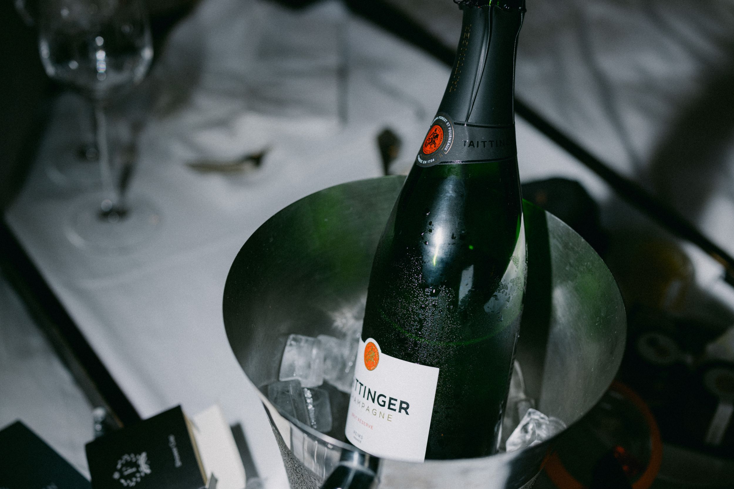 Champagne bottle chilling in ice bucket at elegant reception.