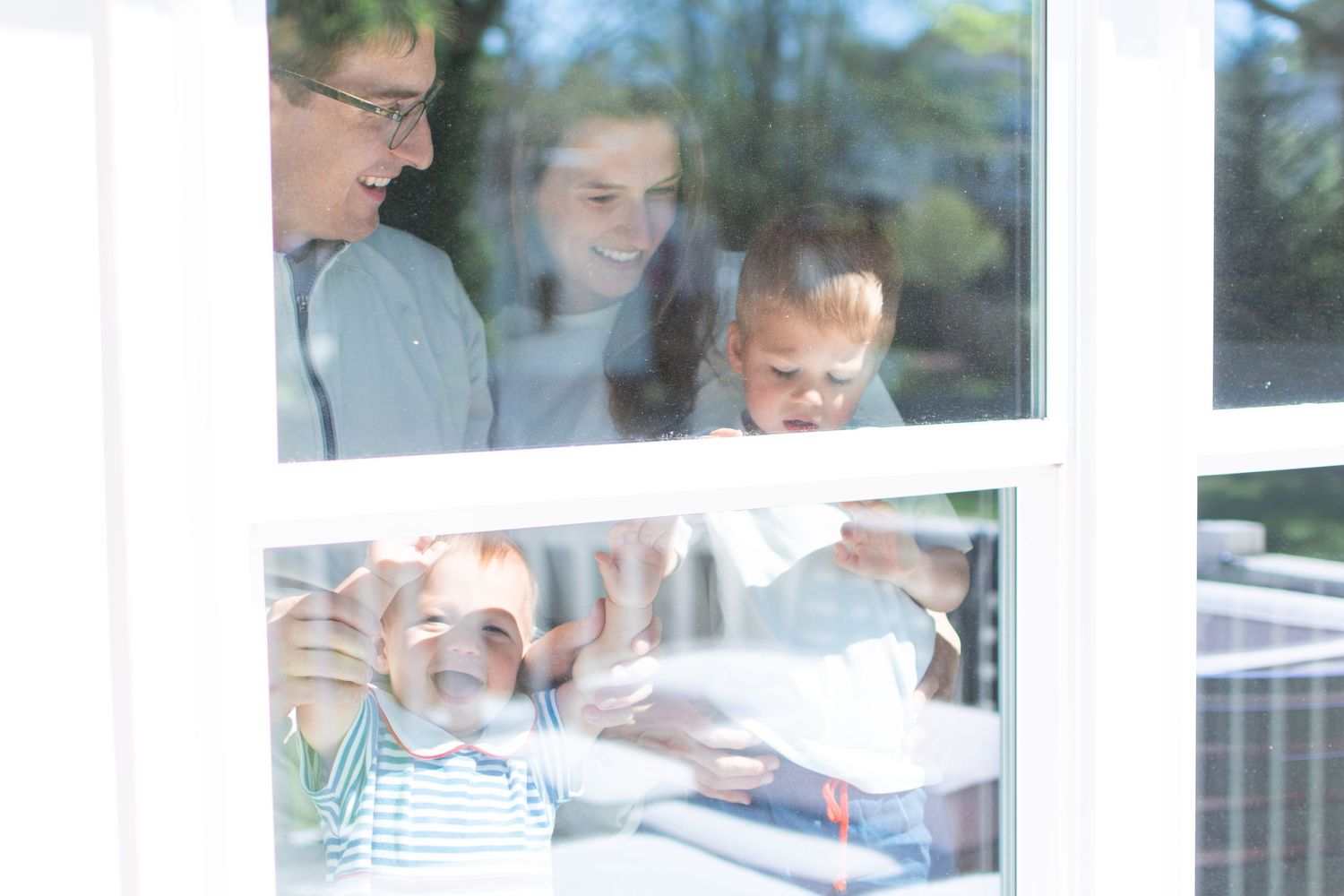 Group studying together through window glass showing collaborative learning environment.