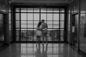 Moody black and white interior scene with dramatic window lighting.