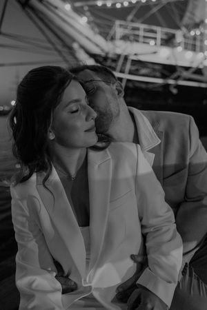 Intimate black and white photo captured in an elegant indoor setting.