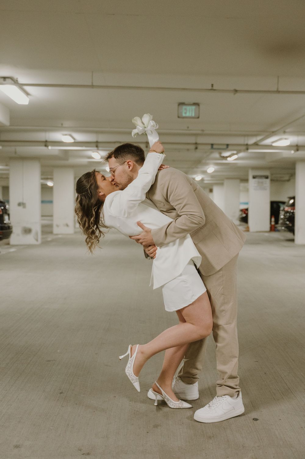 A romantic series of photos in a parking garage showing a couple dancing with dramatic dips.