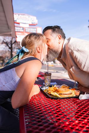 Salt Lake City Utah Photographer, candid relaxed couple on a date night at a drive through diner in sugar house with burgers and fries