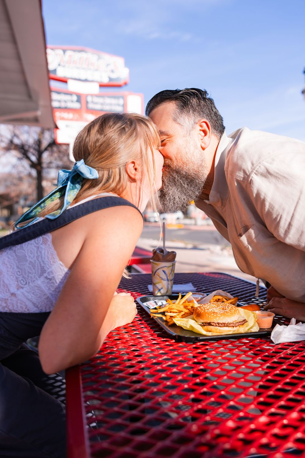 Salt Lake City Utah Photographer, candid relaxed couple on a date night at a drive through diner in sugar house with burgers and fries