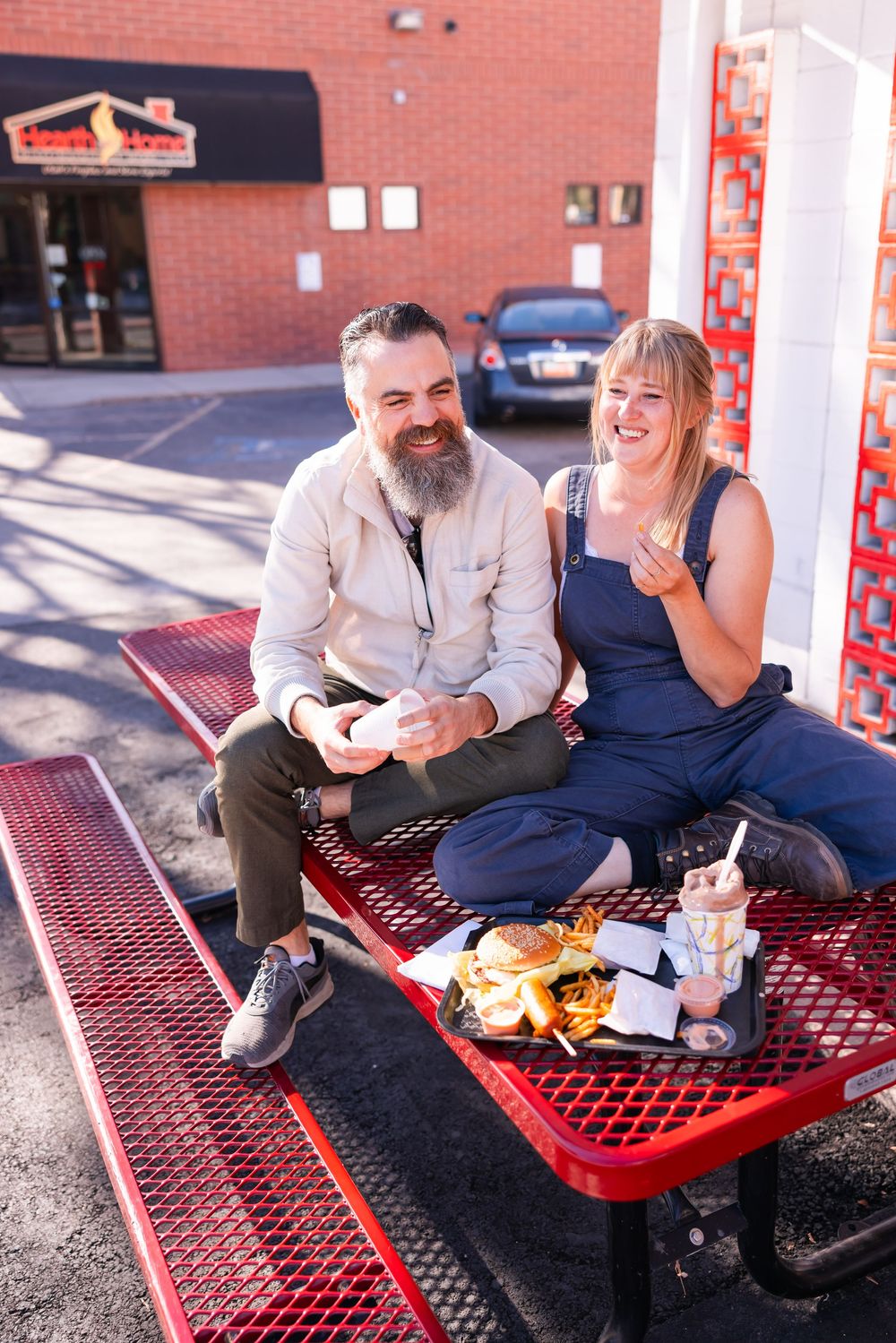 Salt Lake City Utah Photographer, candid relaxed couple on a date night at a drive through diner in sugar house with burgers and fries