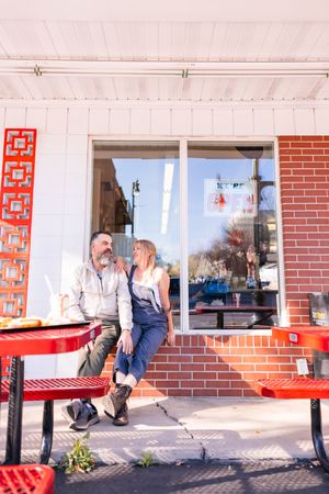Salt Lake City Utah Photographer, candid relaxed couple on a date night at a drive through diner in sugar house with burgers and fries