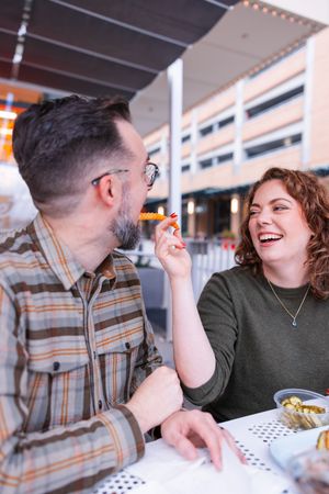 Salt Lake City Utah Photographer, candid relaxed couple on a date night at a diner with burgers and fries