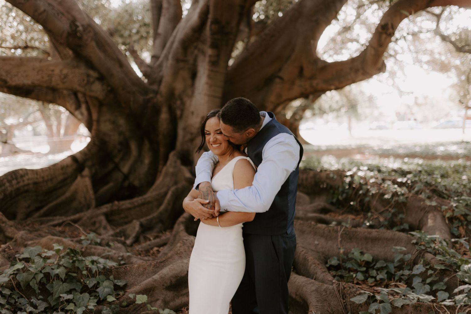 Romantic portraits captured under sprawling oak trees in natural outdoor setting.