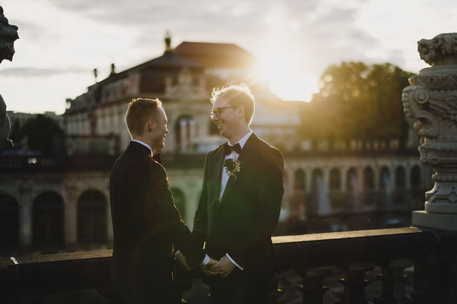 Romantic sunset moment between two people in suits at a historic venue in Dresden. Organized wedding by MyCastleWedding in Dresden/Germany