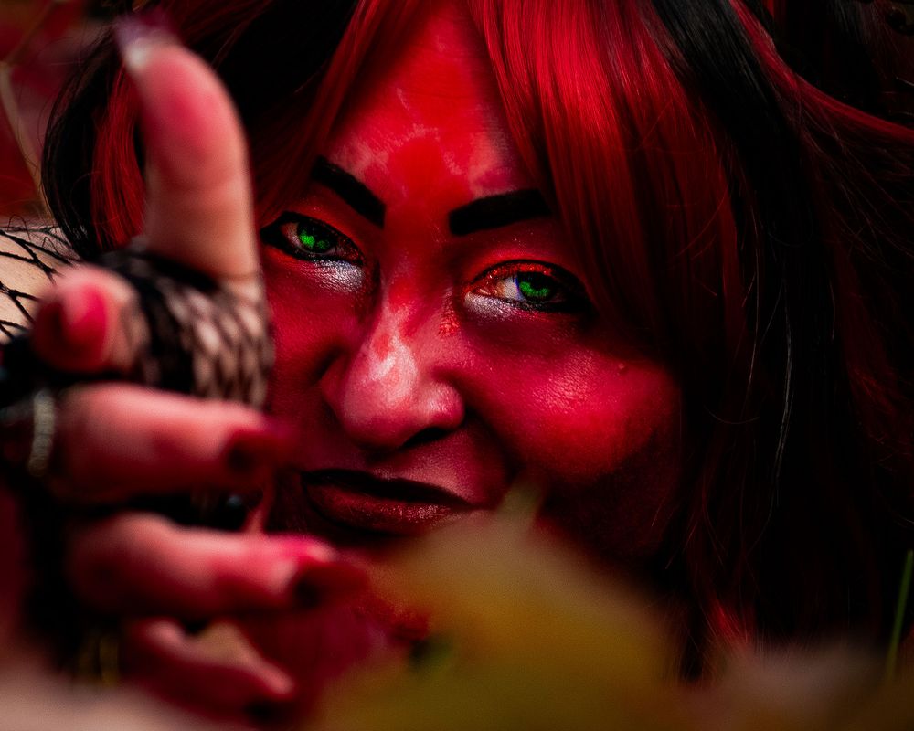 Artistic close-up portrait bathed in dramatic red lighting and shadows. Mermaid
