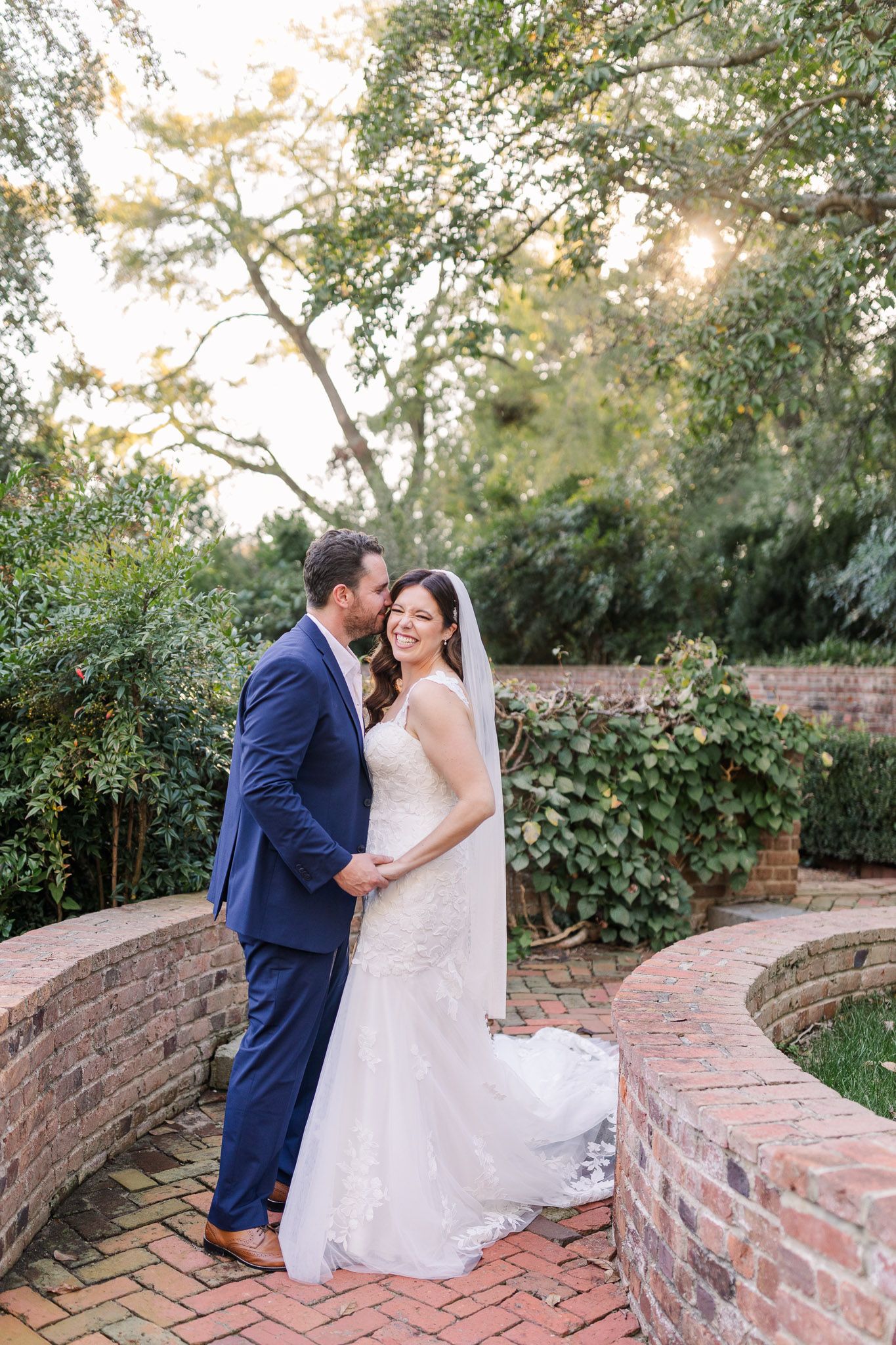 A bride and groom laugh together in the gardens after their wedding at the Virginia House in Richmond, VA.