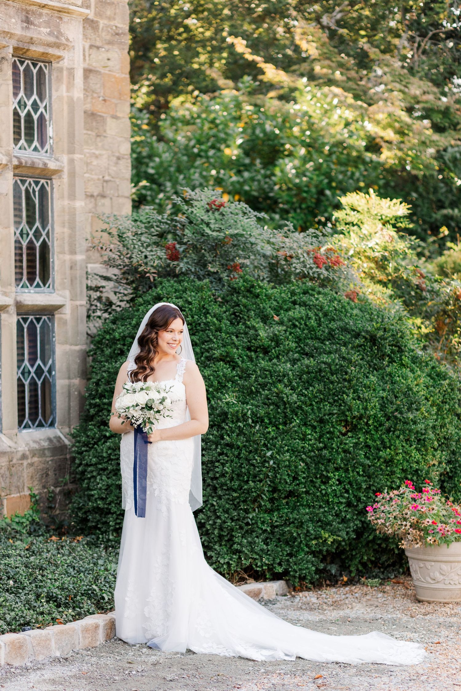 Beautiful bride stands in front of the Virginia House in Richmond, VA before her fall wedding.
