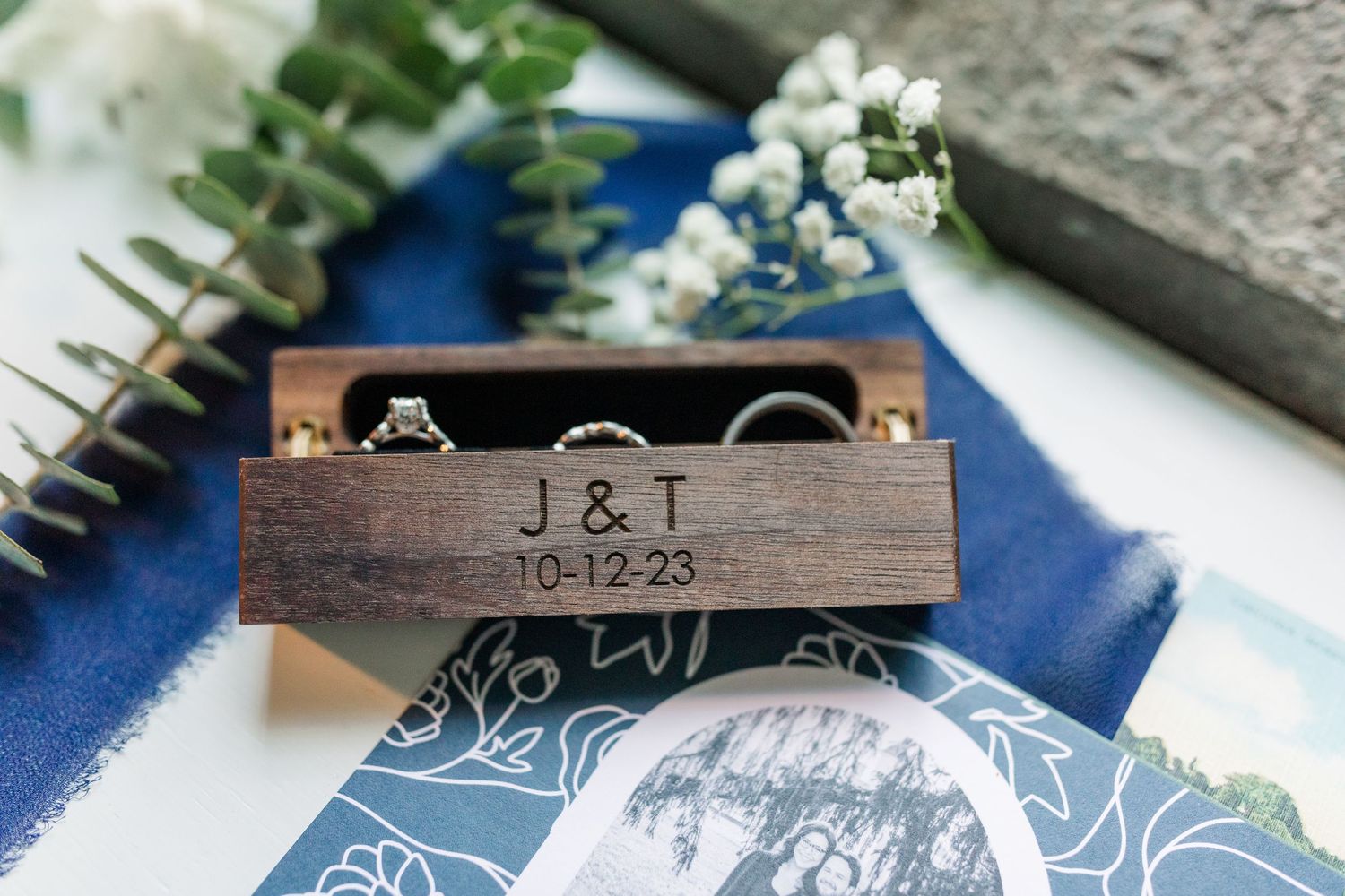 Wedding details with three rings in a wooden ring box at the Virginia House in Richmond, VA.