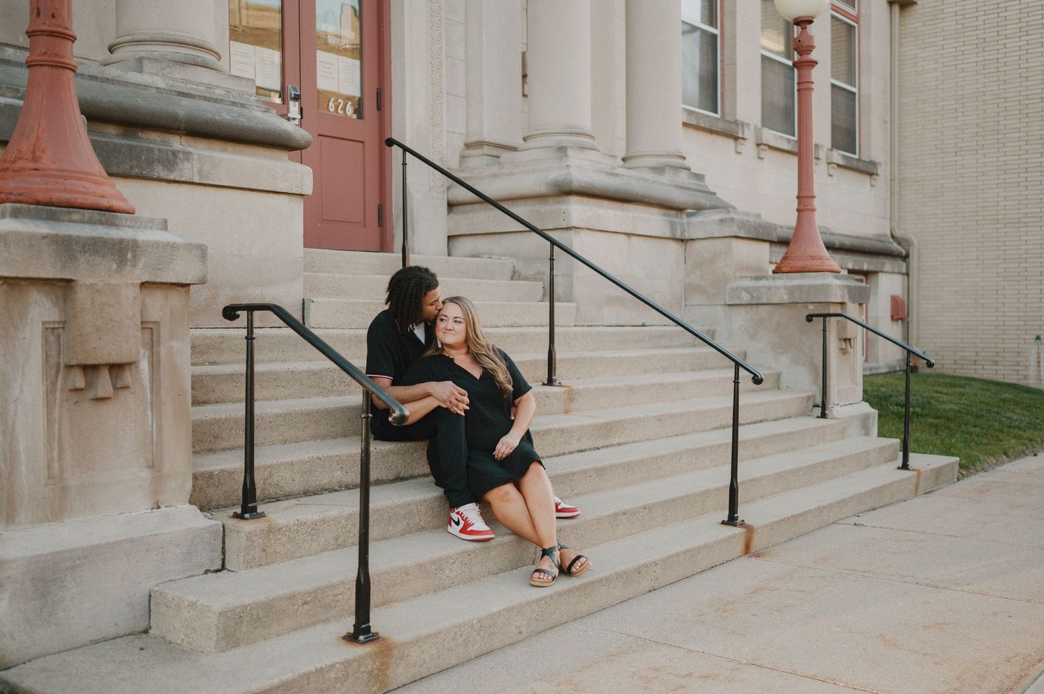 Engagement photo of couple at Drake's Diner in Des Moines, Iowa sharing a milkshake