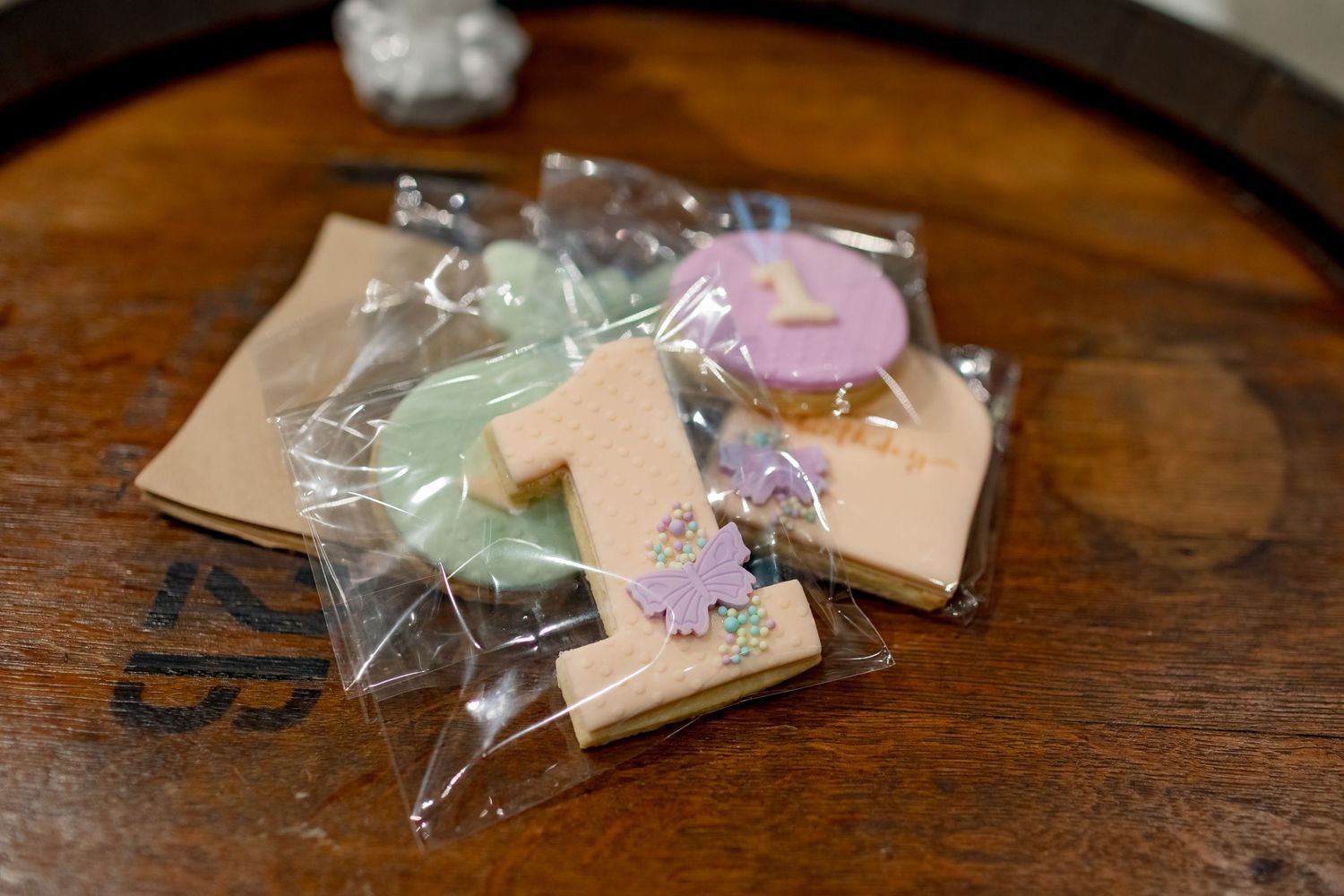 Colorful wrapped party favors displayed on a wooden surface.