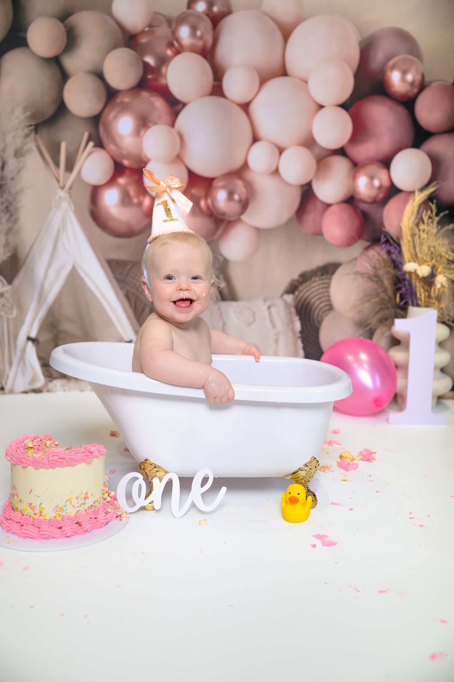 First birthday photo setup with balloon arch and illuminated number one sign. Cake Smash in Penistone Studio