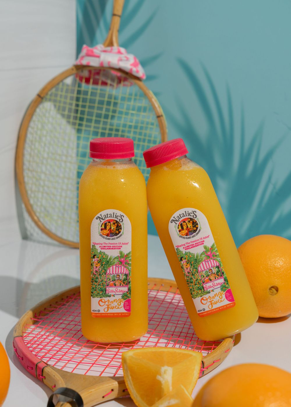 Nat's organic OJ in Lilly Pulitzer plastic bottles balanced on top of tennis rackets