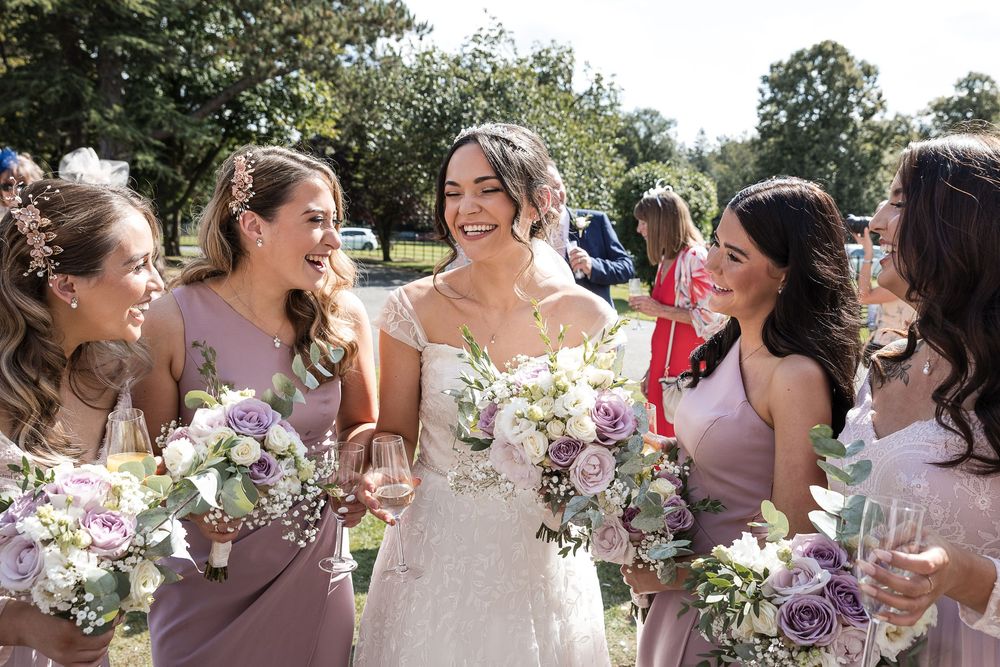 Wedding party laughs together at Kelham House.