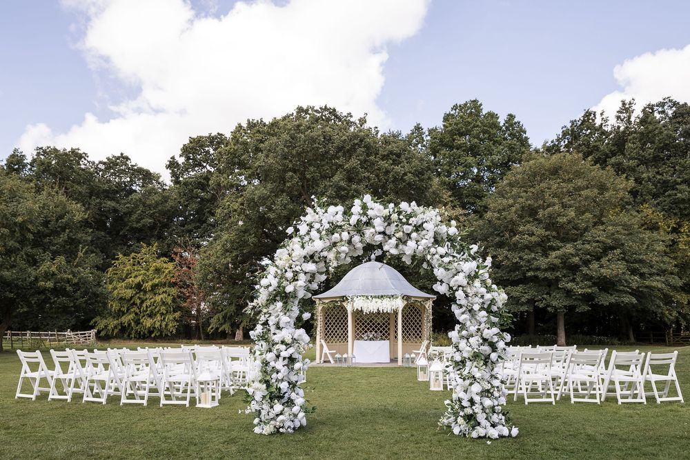 Outdoor gazebo wedding ceremony ready with floral decorations at Kelham House.
