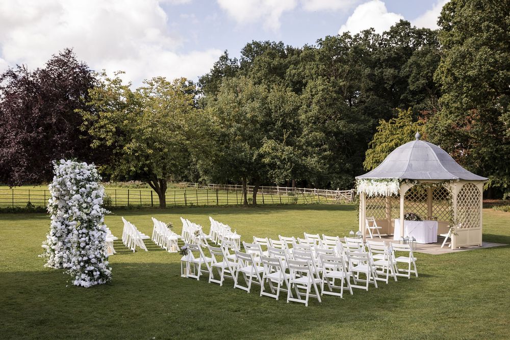 Outdoor gazebo wedding ceremony ready with floral decorations at Kelham House.