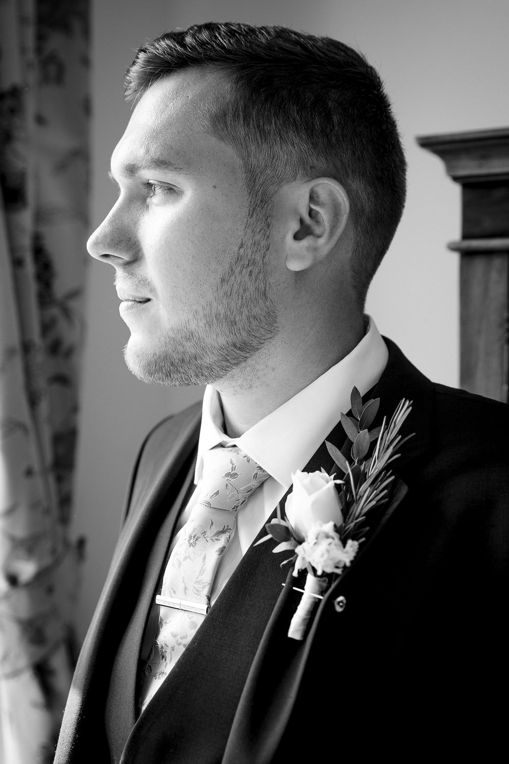 Black and white profile portraits showing groomsman wearing a formal suit at Kelham House.