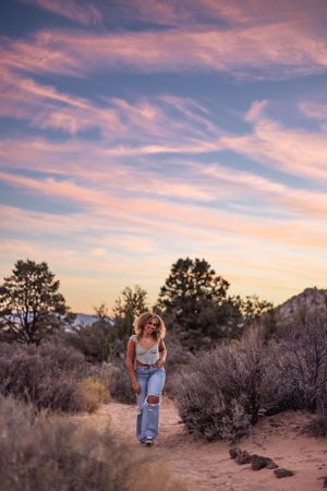 Person hiking desert trail during dramatic purple sunset in Southern Utah