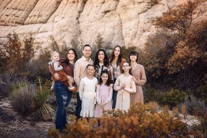 Family group portrait in front of desert rock formation in Southern Utah