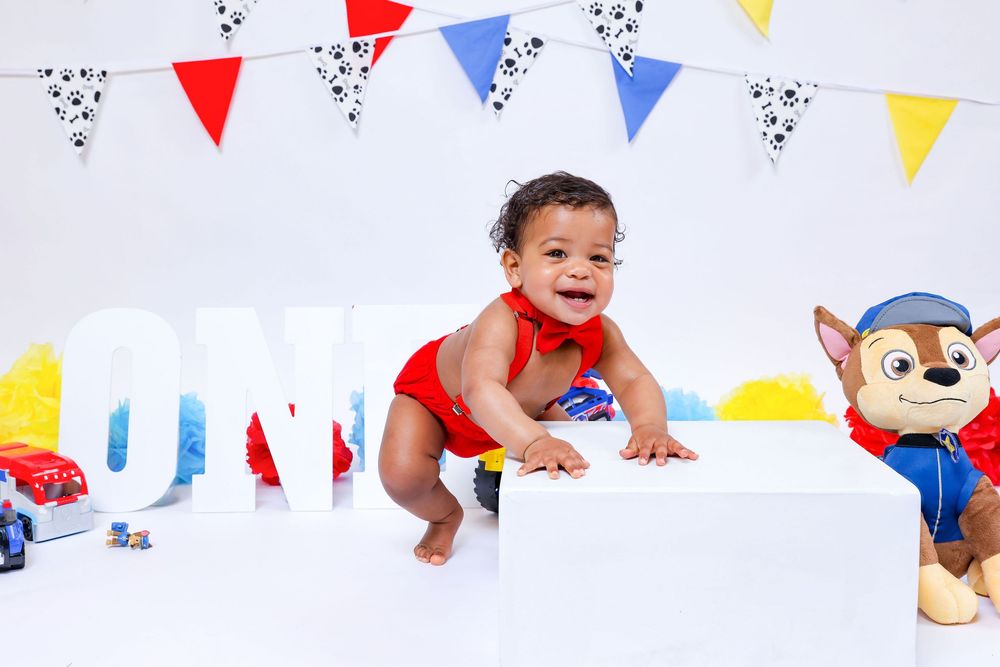 Colorful party banner with blue, red and yellow triangle flags against white background.